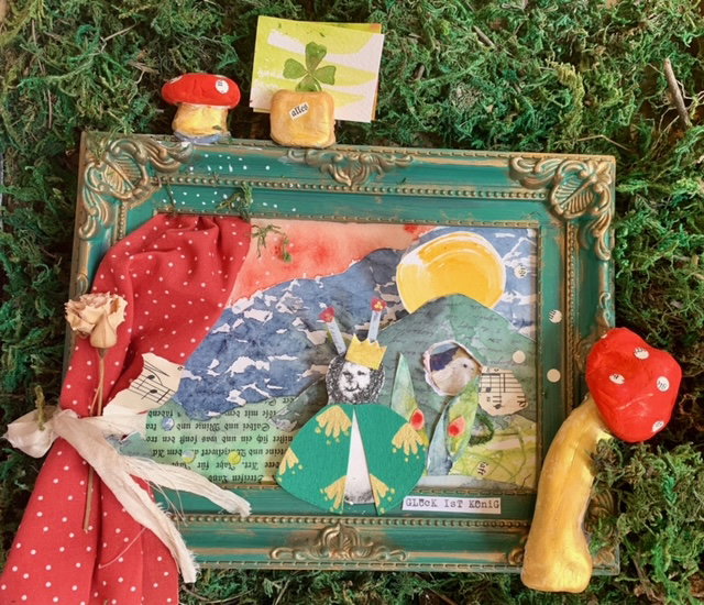mixed media art studio with colorful paints and paper layers