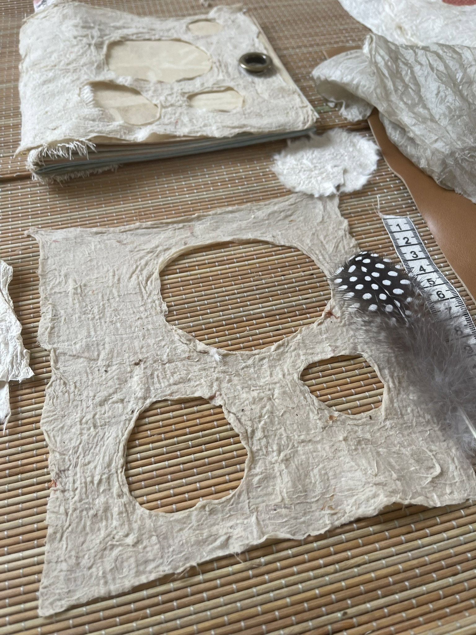 Finished artistic Joomchi wall hanging with intricate holes and lace-like texture